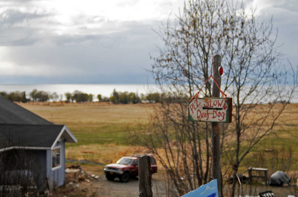 Photo by Elizabeth Earl/Peninsula Clarion A sign on Corea Bend Road near Clam Gulch, Alaska, warns drivers to watch out for a neighbor's deaf dog on Friday, April 29, 2016. Neighbors are concerned about additional traffic on their road if a proposed gravel pit is built on an adjoining property.
