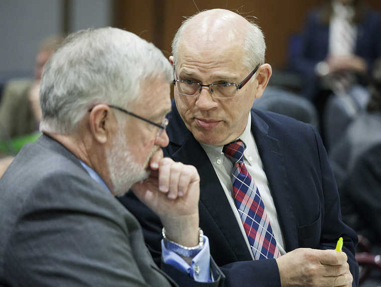 Sen. John Coghill, R-North Pole, right, chats with a colleague after a state Senate floor session, Wednesday, May 4, 2016, in Juneau, Alaska. Coghill championed a massive criminal justice overhaul bill this session but its prospects for passing seem increasingly slim as lawmakers continue to amend and add new provisions to the bill. (AP Photo/Rashah McChesney)