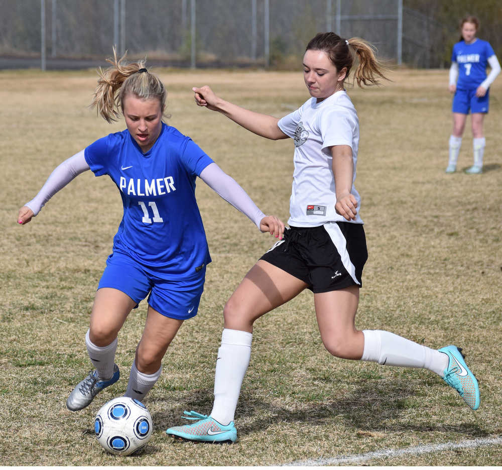 Photo by Joey Klecka/Peninsula Clarion Palmer's Haley Hanson (left) looks to possess the ball before Nikiski's Verity Feltman boots it Friday at Nikiski High School.