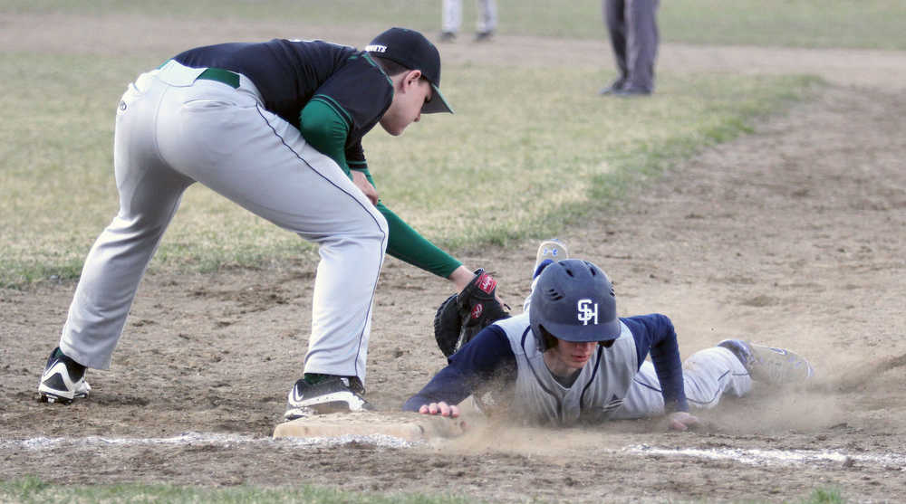 Soldotna's Caleb Spence slides underneath the tag of Colony first baseman Zachary Sattetly during a win over the Knights May 6, 2016, at the Palmer Senior Field in Palmer.
