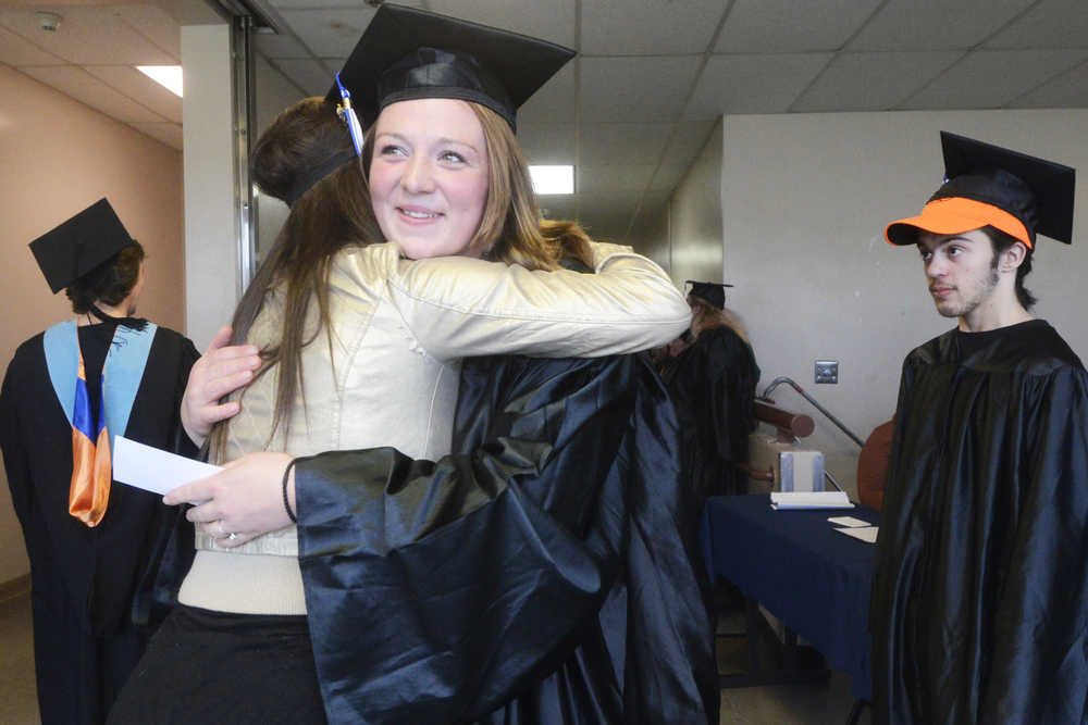 Photo by Megan Pacer/Peninsula Clarion Soldotna residents Cassandra Boze, left, and Becca Satathite share a laugh just before their graduation ceremony on Thursday, May 5, 2016 in the Renee C. Henderson Auditorium at Kenai Central High School in Kenai, Alaska. Boze graduated with a Associate Degree of Appied Science in Nursing, and Satathite with an Associate Degree of Applied Science in Paramedic Technology.