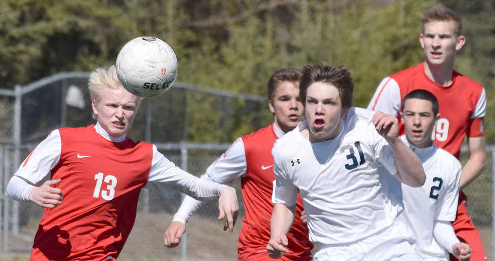 Photo by Joey Klecka/Peninsula Clarion Wasilla's Trout Millhouse (13) eyes a corner kick shot with Soldotna sophomore Eli Sheridan (31) Saturday afternoon at Justin Maile Field in Soldotna.