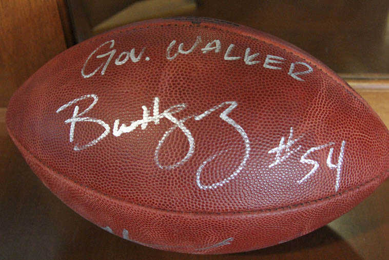 This photo taken Friday, May 6, 2016, in Anchorage, Alaska, shows a football that was presented to Alaska Gov. Bill Walker from Seattle Seahawks linebacker Bobby Wagner during an event for youth at Covenant House in Anchorage. During roughly his first year and a half in office, Walker has receives gifts ranging from alcohol to sea otter mittens to a framed photo from the King of Norway, presented by King Harald V himself. (AP Photo/Mark Thiessen)
