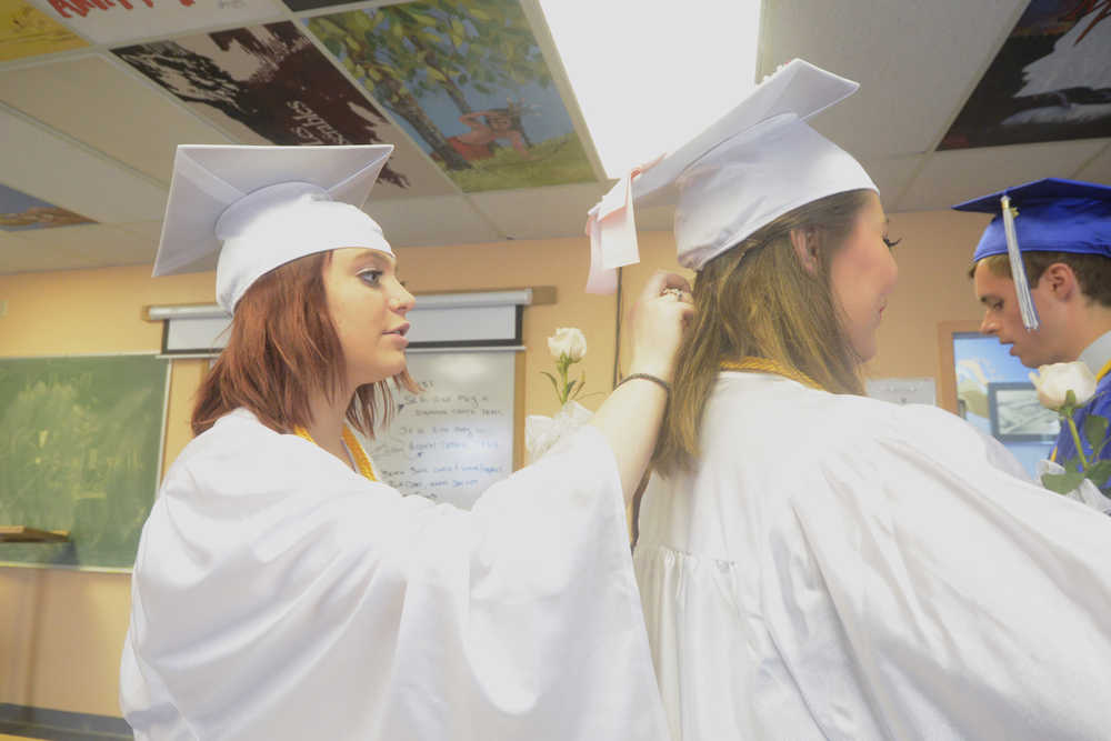 Photo by Megan Pacer/Peninsula Clarion Richele McGahan adjusts the pins in Victoria Cizek's hair moments before they joined their two fellow senior classmates to walk into their graduation ceremony Sunday, May 8, 2016 at Cook Inlet Academy in Soldotna, Alaska. The school had a smaller graduating class than usual, with only four high school seniors.