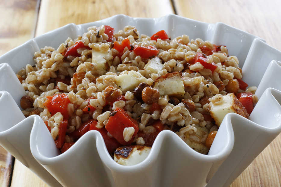 This March 14, 2016 photo, shows a chickpea and farro Salad in Concord, N.H. It combines savory roasted chickpeas with grill hallmoumi cheese and nutty cooked farro for a light, but hearty spring salad. (AP Photo/J.M. Hirsch)