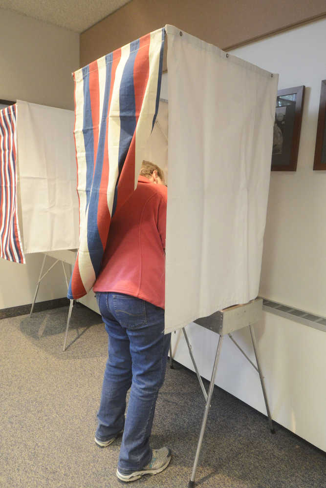 Photo by Megan Pacer/Peninsula Clarion A voter fills out her ballot during a special election Tuesday, May 10, 2016 at Soldotna City Hall in Soldotna, Alaska. The election held to decide if the city would form a charter commission saw a steady stream of voters during lunchtime hours.