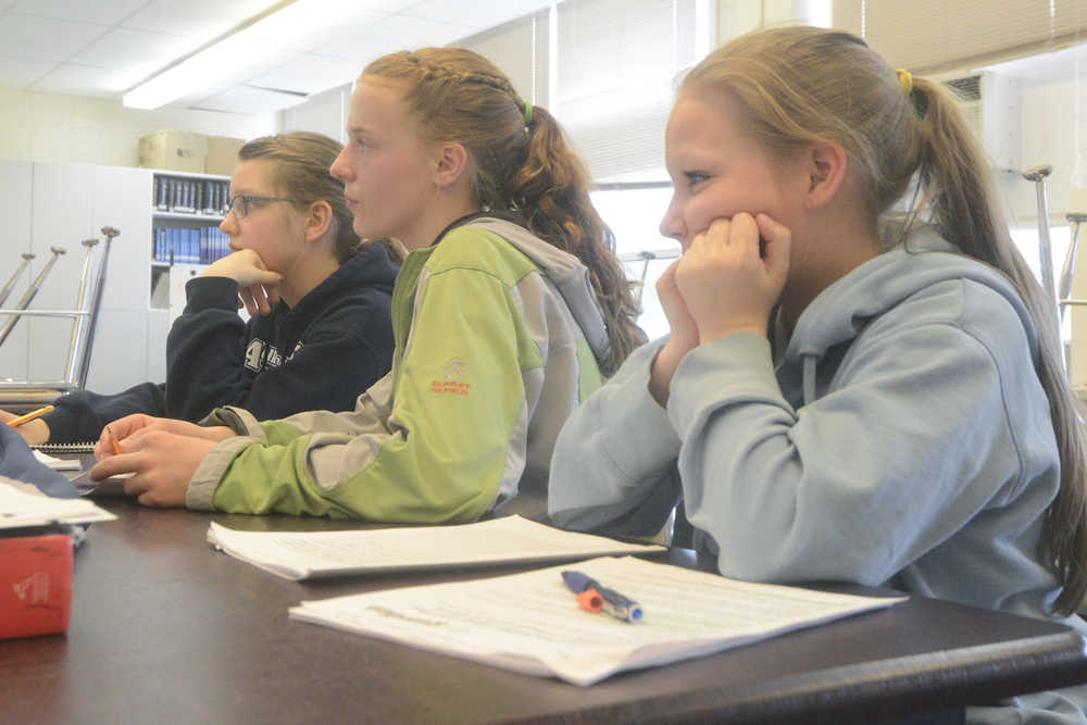 Photo by Megan Pacer/Peninsula Clarion From left: Melita Efta, 12, Bailey Epperheimer, 13, and Shelbie Naylor, 12, take in new information during a team practice session Monday, May 10, 2016 at Aurora Borealis Charter School in Kenai, Alaska. The girls and their fourth teammate will travel with an older group from Kenai Central High School to compete in the Future Problem Solving Program 2016 International Conference in Michigan in June.