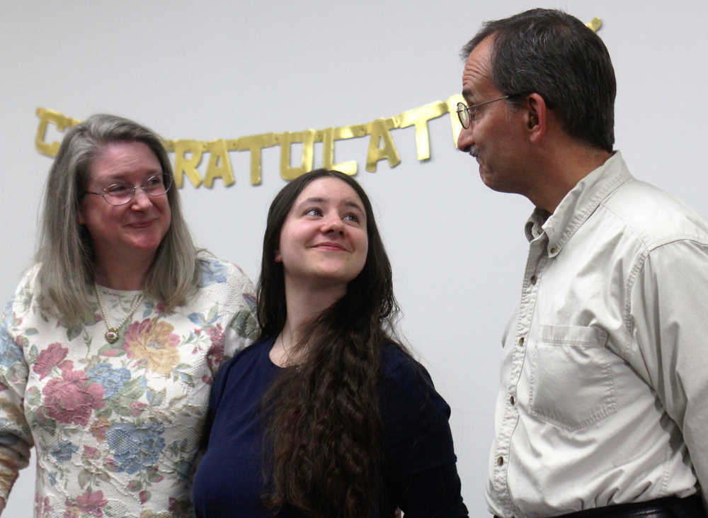 Deborah Glick (center) stands between her parents during the IDEA Homeschool group's celebration of its 2016 graduates on Friday, May 13 in Soldotna.