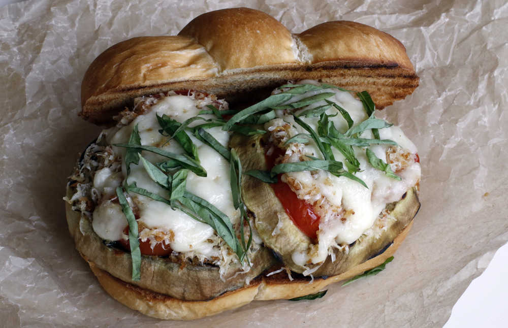 This April 2016 photo shows grilled eggplant parmigiana in Concord, N.H.  This dish, a staple of Italian cuisine, is a wonderful candidate for the grill, cooking up quickly and cleanly. And grilling this dish not only requires less oil than the traditional recipe, it ends up imparting a smokiness it could never claim before. (AP Photo/J.M. Hirsch)