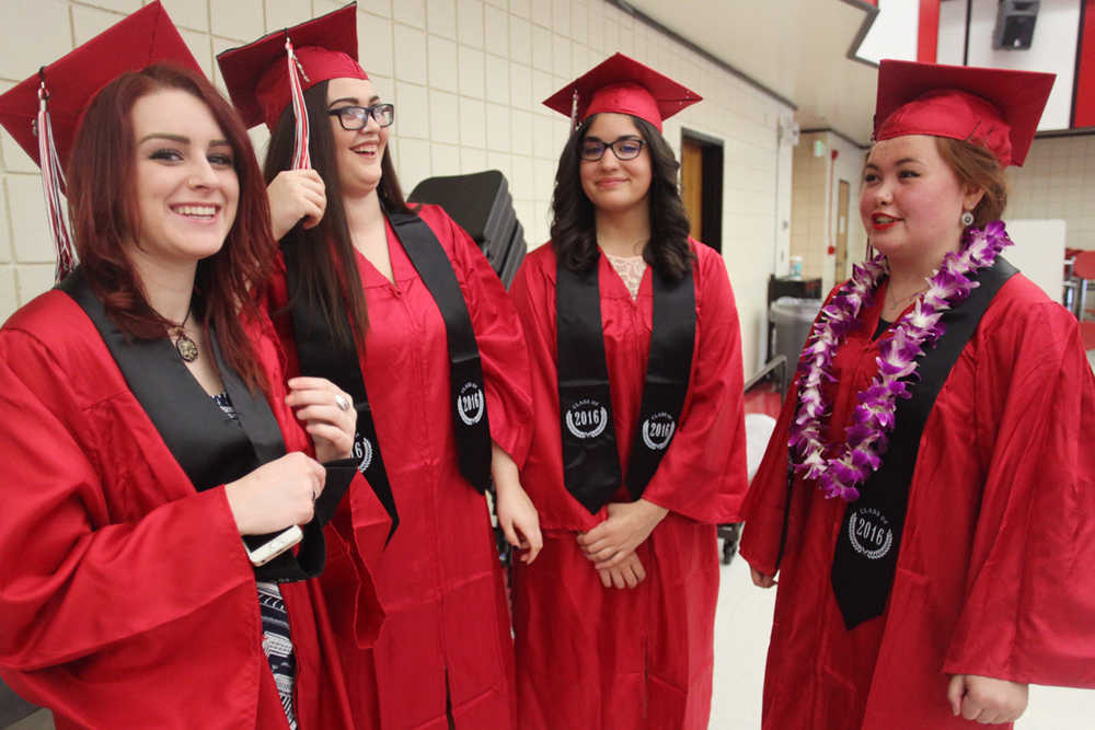 Photo by Kelly Sullivan/ Peninsula Clarion (Left to right) Suzy Sylvester, Darian Saltenberger, Annika Oren and Mariah Graham spend a few last minutes together in the school lunchroom before the graduation ceremony begins Tuesday, May 18, 2016, at Kenai Central High School in Kenai, Alaska.