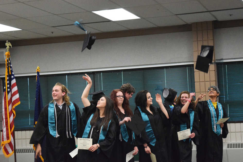 Photo by Megan Pacer/Peninsula Clarion This year's nine graduates of River City Academy toss their caps into the air after getting their diplomas during a graduation ceremony Tuesday, May 17, 2016 at the Soldotna Regional Sports Complex in Soldotna, Alaska.