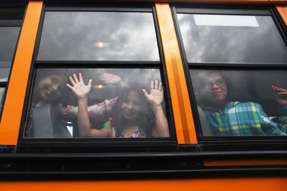 Photo by Kelly Sullivan/ Peninsula Clarion (left) A group of students waves to their teachers, friends and classmates on the last day of school Wednesday, May 18, 2016, at Kalifornsky Beach Elementary in Soldotna, Alaska.