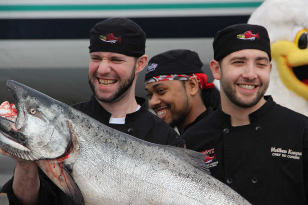 From left to right, Sean Kelly of Humpy's Great Alaskan Alehouse, Bartol Seay of Flattop Pizza + Pool and Matthew Kenyon of Humpy's take a look at the first king salmon. (Photo by DJ Summers/Alaska Journal of Commerce)