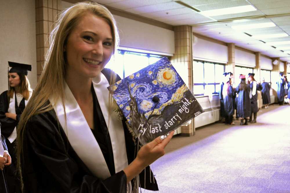 Photo by Elizabeth Earl/Peninsula Clarion Daisy Nelson hand-painted her cap for her graduation fro Soldotna High School at the Soldotna Regional Sports Complex on Wednesday, May 18, 2016. Nelson said she has been painting since she was 5 years old and intends to use her art for a career in marketing or advertising.
