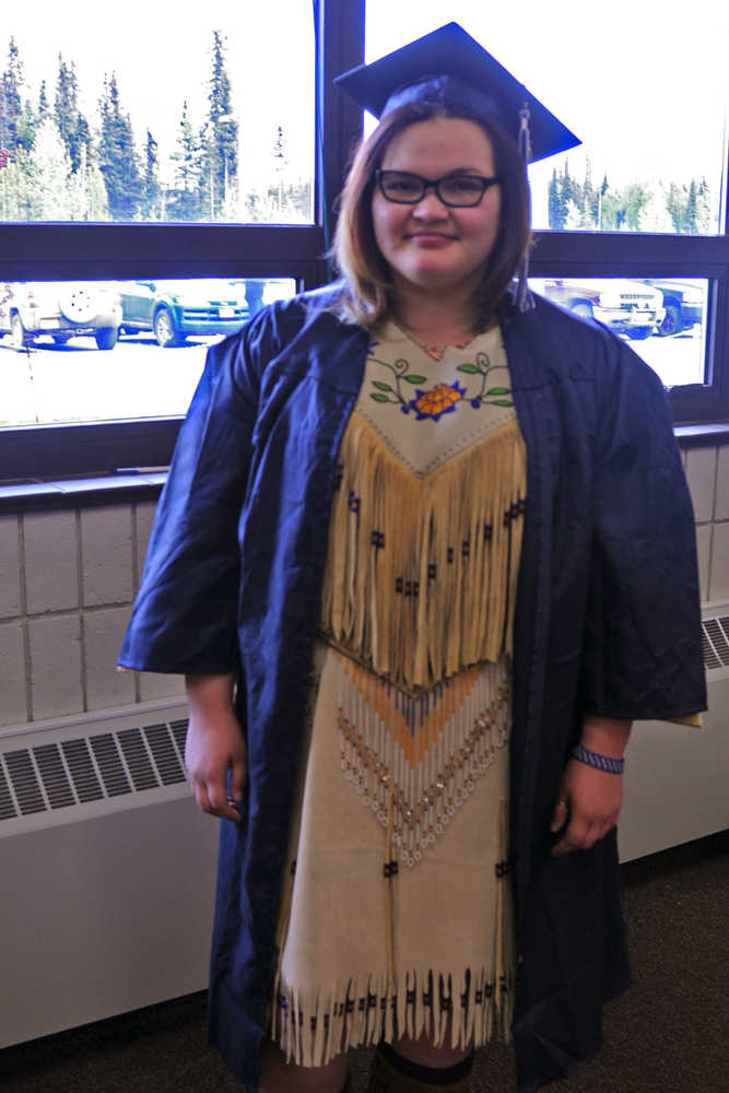 Photo by Elizabeth Earl/Peninsula Clarion Laural Schadle, a graduate from Soldotna High School, spent two and a half months hand-beading her dress with the help of her grandmother specifically for the graduation ceremony at the Soldotna Regional Sports Complex on Wednesday, May 18, 2016. Schadle said it is a family tradition to make a new dress for significant life events.