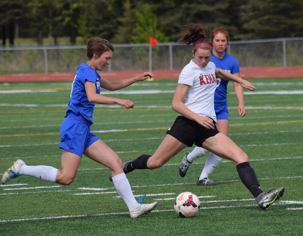 Photo by Joey Klecka/Peninsula Clarion Kenai Central junior Lara Creighton (right) dribbles the ball against Palmer's Elliese Wright in a Northern Lights Conference tournament quarterfinal Thursday afternoon at Ed Hollier Field in Kenai.