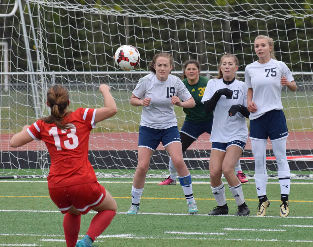 Photo by Joey Klecka/Peninsula Clarion Soldotna's Alyssa Wolfe (19), Jaela Hubbard (23) and Talon Hagen (75) form a wall in front of a free kick from Wasilla's Alexis Friesen (13), Friday at Ed Hollier Field in Kenai. SoHi goalkeeper Maddie Kindred looks on in back.