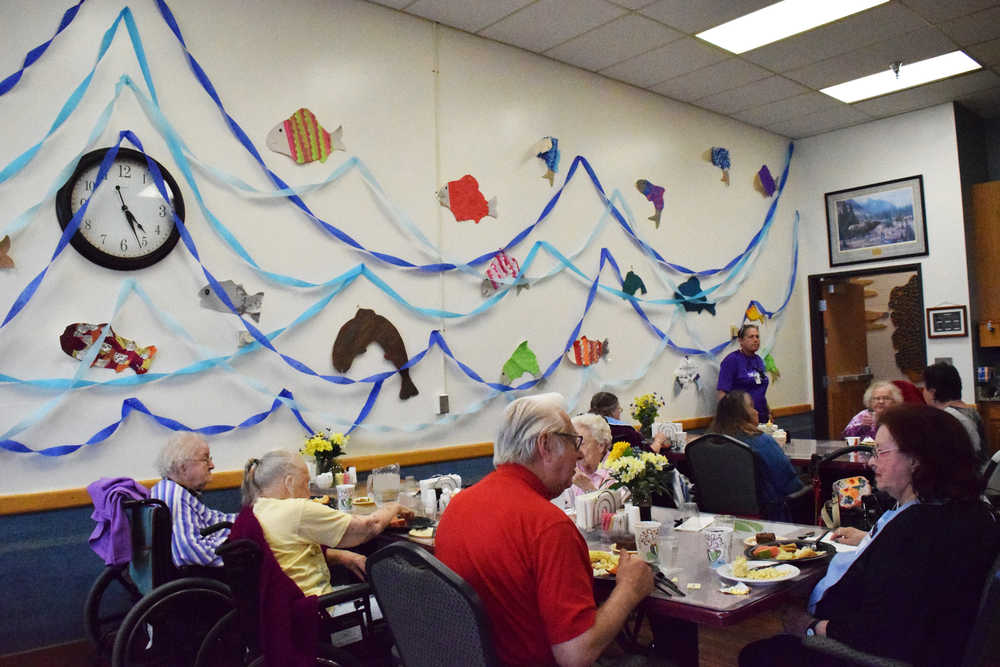 Photo by Megan Pacer/Peninsula Clarion Residents of Heritage Place enjoy a meal duirng the annual Return of the Salmon event Friday, May 20, 2016, at Heritage Place in Soldotna, Alaska.