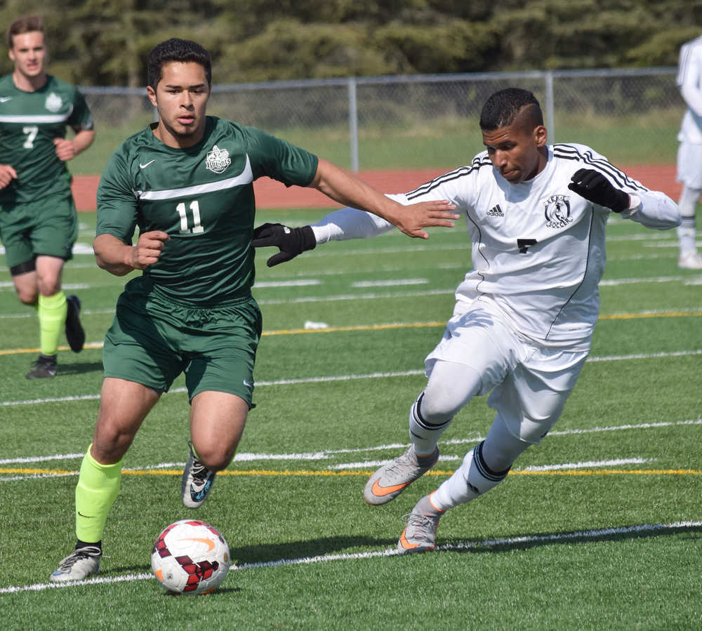 Photo by Joey Klecka/Peninsula Clarion Colony forward Alex Valdez (11) battles for possession with Kenai Central midfielder Kevin Ramos in Saturday's Northern Lights Conference championship game at Ed Hollier Field in Kenai.