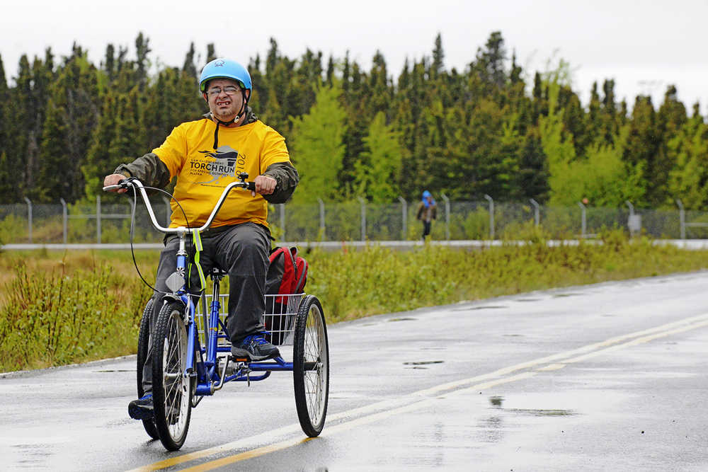 Shane Hawkins tricycles toward the turn-around point of the Special Olympics Torch run on Saturday, May 21 near the intersection of North Willow Street and Marathon Road in Kenai. Participants in the annual fundraising event ran, walked, rollerbladed, or rode to the turn-around and back from Kenai's park strip at First Street and Main Street Loop.