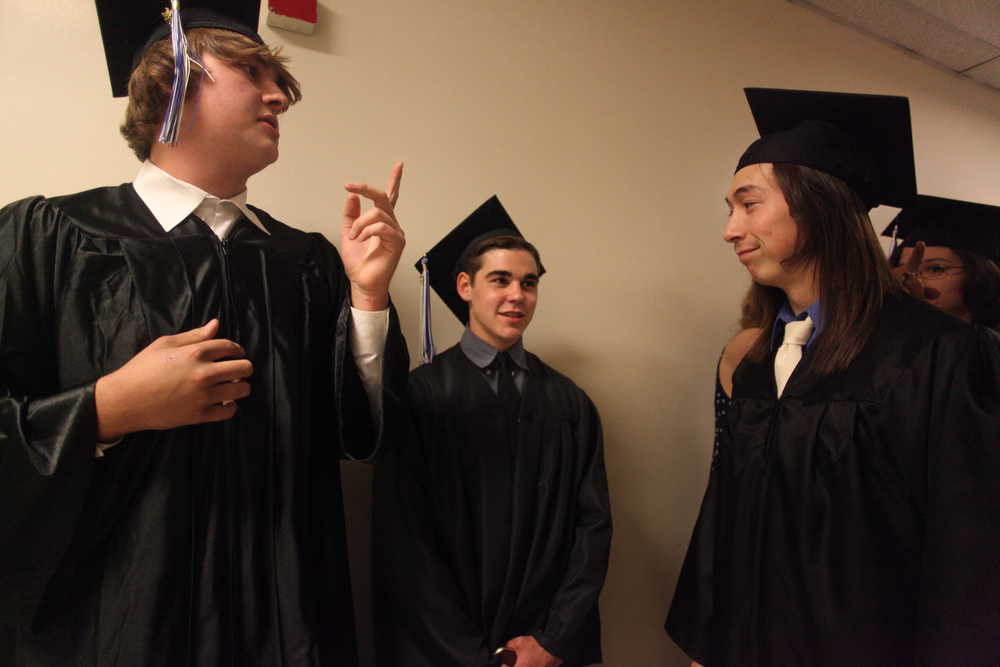 Photo by Kelly Sullivan/ Peninsula Clarion Bruce Howell, Seth Hutchison and Toma Johnson chat before heading on stage to the Connections Home School Graduation Thursday, May 19, 2016, at Soldotna High School in Soldotna, Alaska.