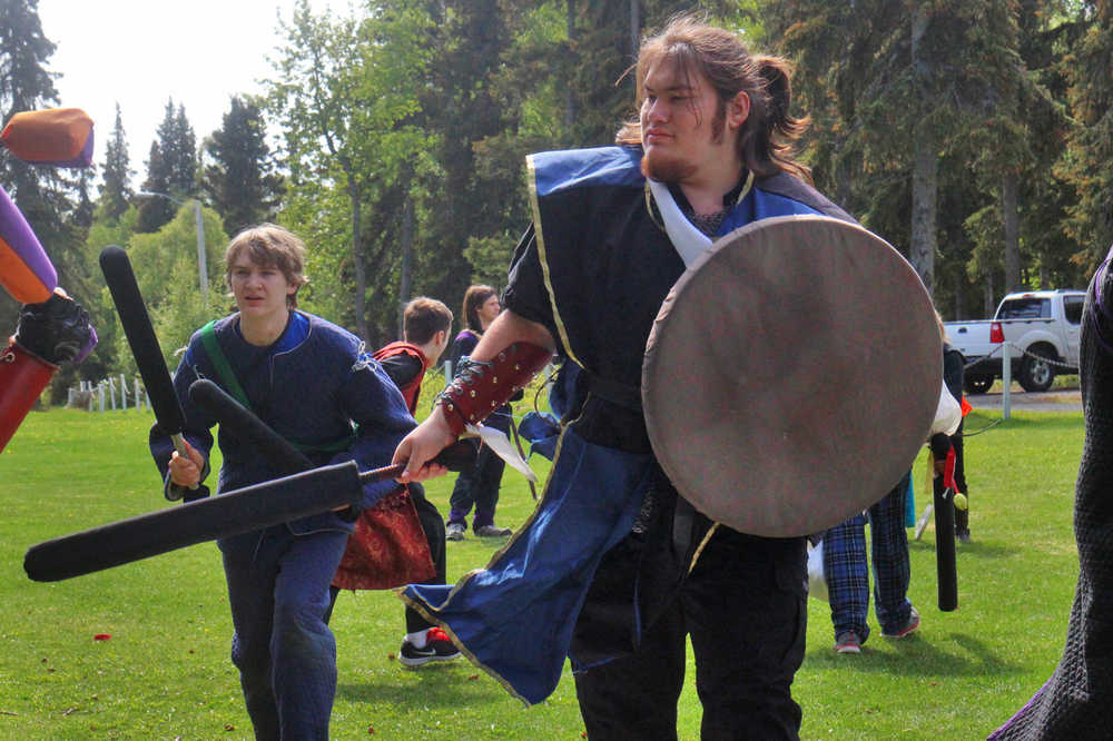 Will Brighton (left) and Conner Christoffersen prepare for a fight during the Frozen Coast live-action role play group's weekly battle game on Sunday, May 22 in the Kenai Municipal Park.
