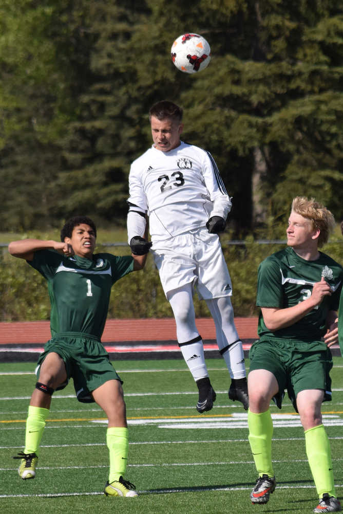 Photo by Joey Klecka/Peninsula Clarion Kenai Central midfielder Zack Tuttle (23) heads the ball amid a group of Colony defenders Saturday, May 21, at Ed Hollier Field in Kenai. The Kenai boys won the Northern Lights Conference championship with a 3-1 victory over Colony.