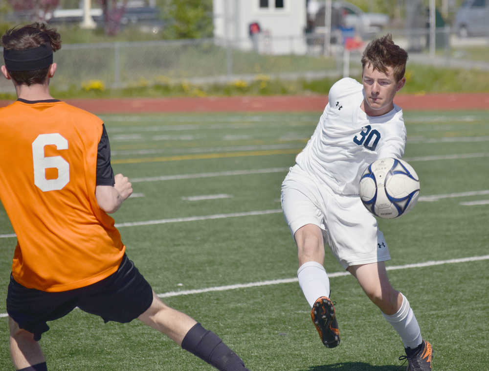 Photo by Joey Klecka/Peninsula Clarion Soldotna sweeper Ethan Bott (30) keeps the ball away from West Anchorage's Cannen Burgess at the ASAA state soccer tournament Thursday at Eagle River High School.