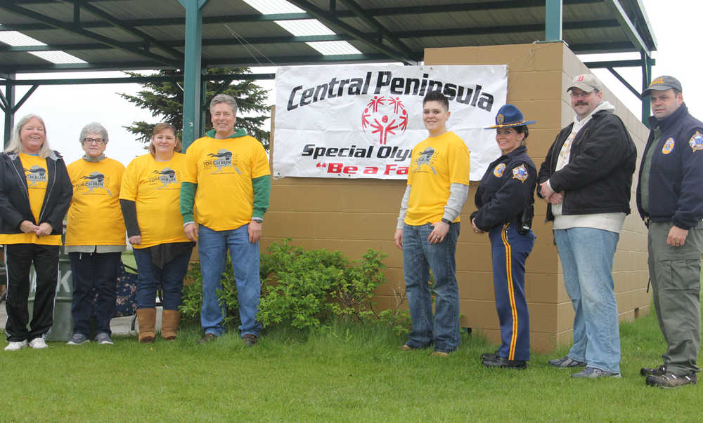 Torch keeps burning during run in the rain for Special Olympics