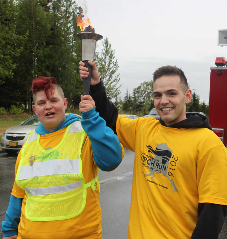 Torch keeps burning during run in the rain for Special Olympics