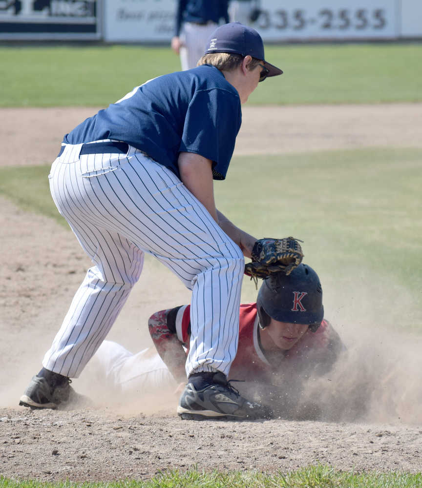 Photo by Jeff Helminiak/Peninsula Clarion Kenai Central's Paul Steffensen slides under the tag of Soldotna third baseman Jake Marcuson for a stolen base Saturday in the second-place game of the Southcentral Conference tournament at Coral Seymour Memorial Park in Kenai.