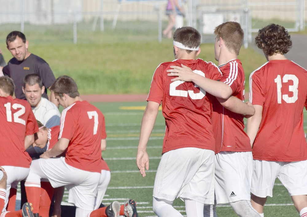 Photo by Joey Klecka/Peninsula Clarion Kenai Central sophomore Zack Tuttle (23) gets a reassuring hug from teammate Rykker Riddall after Saturday's state soccer championship final against South Anchorage.