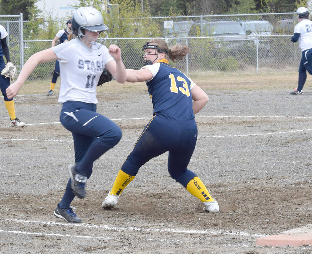 Photo by Jeff Helminiak/Peninsula Clarion Homer's Malina Fellows tries to tag Soldotna's Macylea Elsey in a Homer victory earlier this season in Soldotna.