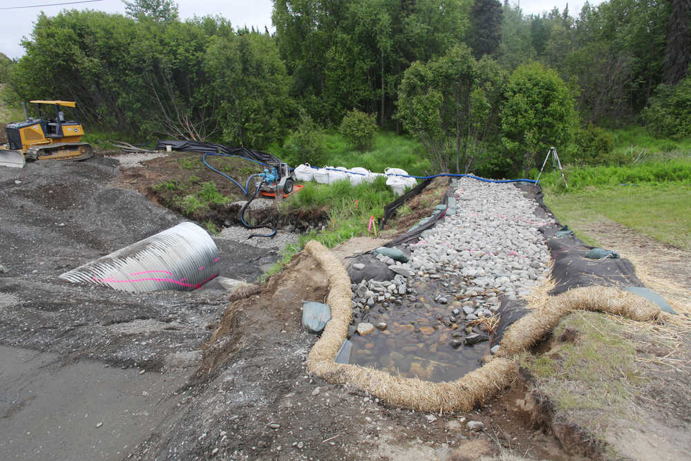 Photo by Kelly Sullivan/ Peninsula Clarion Alaska Department of Transporation employees diverted the creek contained by the aging culvert that is currently being replaced Monday, June 6, 2016, in Kenai, Alaska.