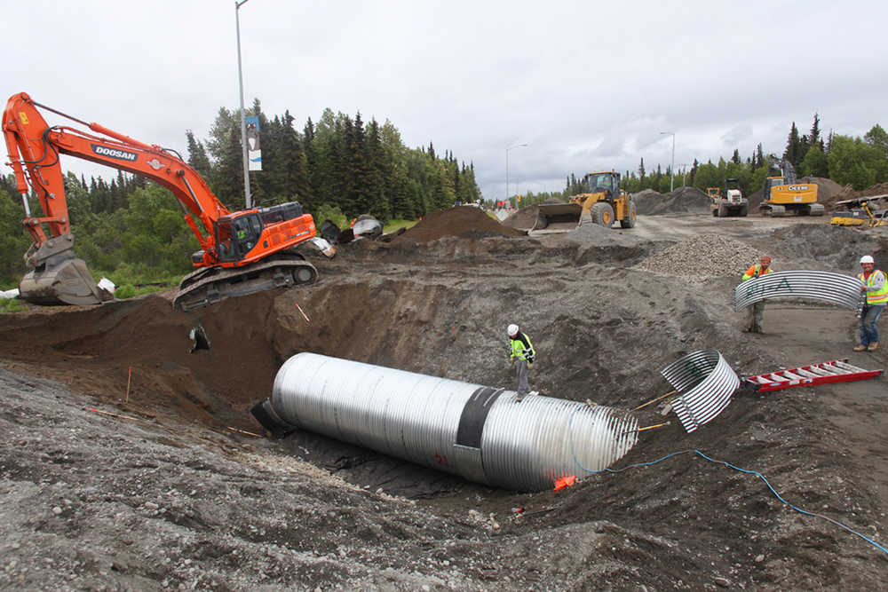 Photo by Kelly Sullivan/ Peninsula Clarion Alaska Department of Transporation employees are working around the clock to finish putting in a culvert at mile 9.8 of the Kenai Spur Highway on Monday, June 6, 2016, in Kenai, Alaska. All traffic was diverted away from the segment of roadway that was closed down entirely for the day, but is expected to open back up Tuesday morning.