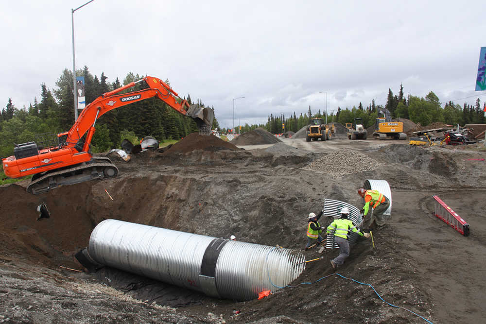 Photo by Kelly Sullivan/ Peninsula Clarion Alaska Department of Transporation employees are working around the clock to finish putting in a culvert at mile 9.8 of the Kenai Spur Highway on Monday, June 6, 2016, in Kenai, Alaska. All traffic was diverted away from the segment of roadway that was closed down entirely for the day, but is expected to open back up Tuesday morning.