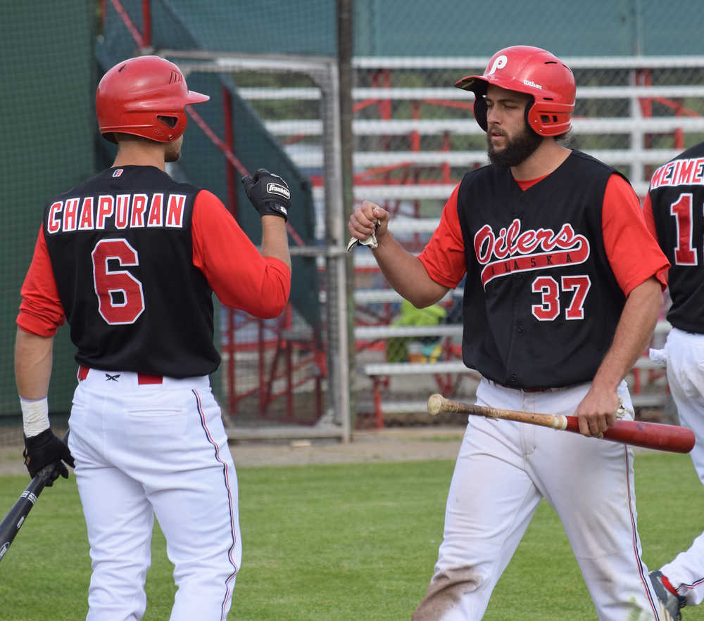 Photo by Joey Klecka/Peninsula Clarion Peninsula Oilers center fielder Brian Ruhm (37) fist bumps short stop Jeff Chapuran after scoring a run Friday night against the Anchorage Glacier Pilots at Coral Seymour Memorial Park in Kenai.