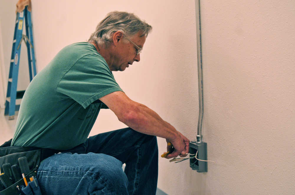 Mike Harris, the owner of Croy's Enterprises, works on some electrical fixtures at his facility near Soldotna, Alaska on Sunday, June 12, 2016. Harris was one of seven marijuana entrepreneurs on the Kenai Peninsula to gain state approval last week.