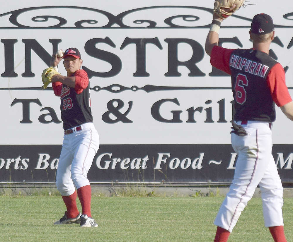 Photo by Joey Klecka/Peninsula Clarion Shih-Tsung Wang makes a throw from the outfield to Peninsula Oilers shortstop Jeff Chapuran June 14 against the Alaska Goldpanners of Fairbanks at Coral Seymour Memorial Field.