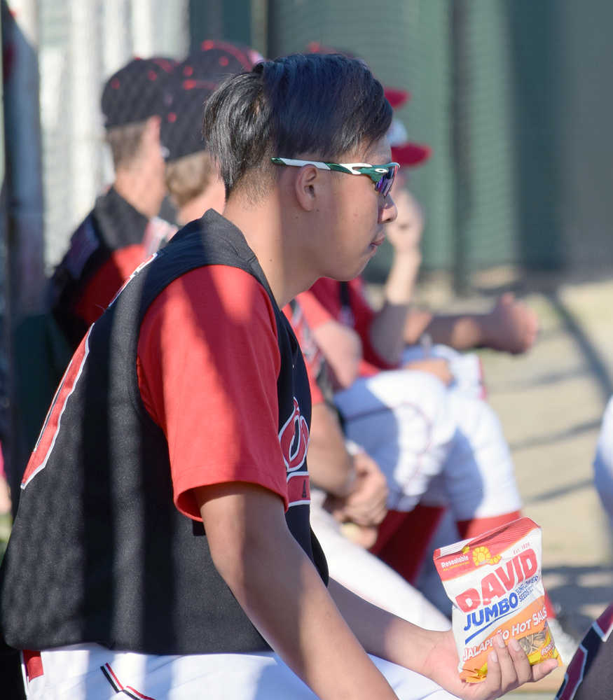 Photo by Joey Klecka/Peninsula Clarion Yi-Hsin Huang scouts out the opposition between pitching stints against the Alaska Goldpanners of Fairbanks June 14 at Coral Seymour Memorial Park in Kenai.