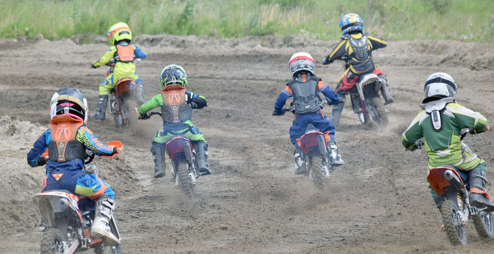 Photo by Joey Klecka/Peninsula Clarion A field of young riders take off in the 50cc Novice category Saturday at the Kenai Peninsula Racing Lions motocross track in Kenai.