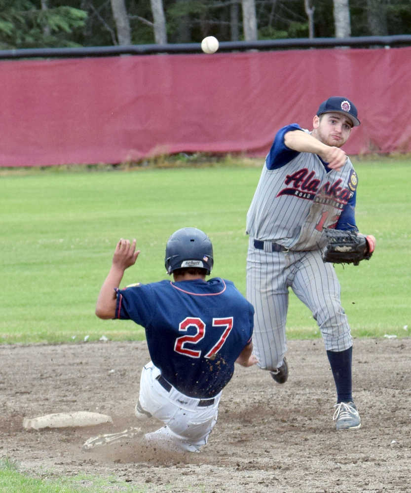 Photo by Jeff Helminiak/Peninsula Clarion Wasilla Road Warriors shortstop Matt Palmer avoids the slide of Twins' Terrance Slats to turn a double play in the eighth inning Friday at the Kenai Little League fields.