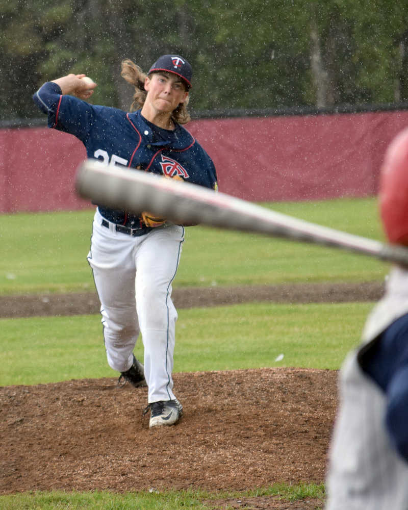 Photo by Jeff Helminiak/Peninsula Clarion Twins pitcher Gavin Petterson delivers home in a passing shower Friday against the Wasilla Road Warriors at the Kenai Little League fields.