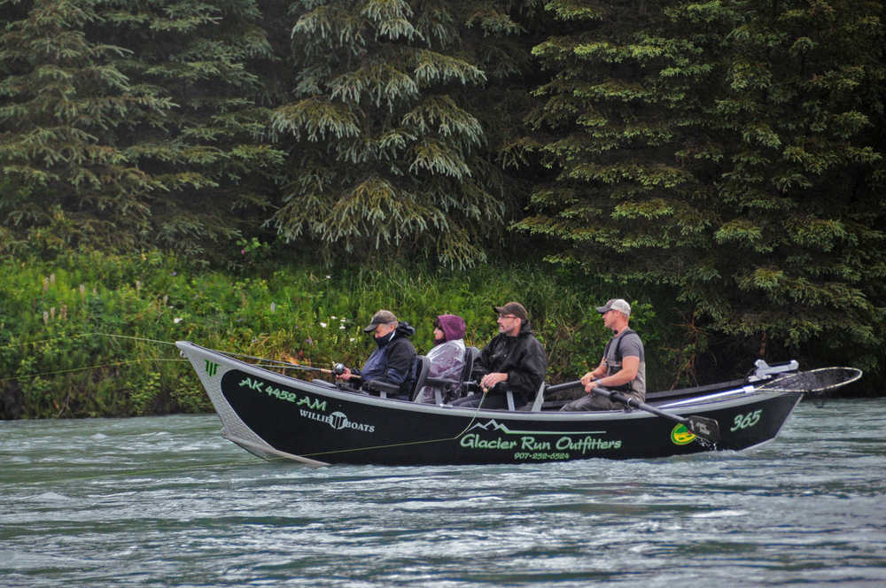 Photo by Elizabeth Earl/Peninsula Clarion A guide rows a boat full of clients on the Kasilof River near Crooked Creek in Kasilof, Alaska on Friday, June 24, 2016.