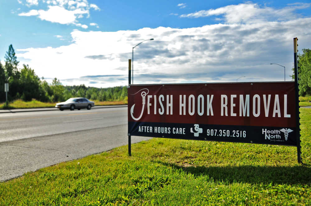 Photo by Elizabeth Earl/Peninsula Clarion A sign for Health North Family Medicine in Soldotna, Alaska, pictured June 29, 2016, offers 24/7 fish hook removal. The clinic probably sees eight to 10 cases of embedded fish hooks per week, said Dr. Rod Hall.