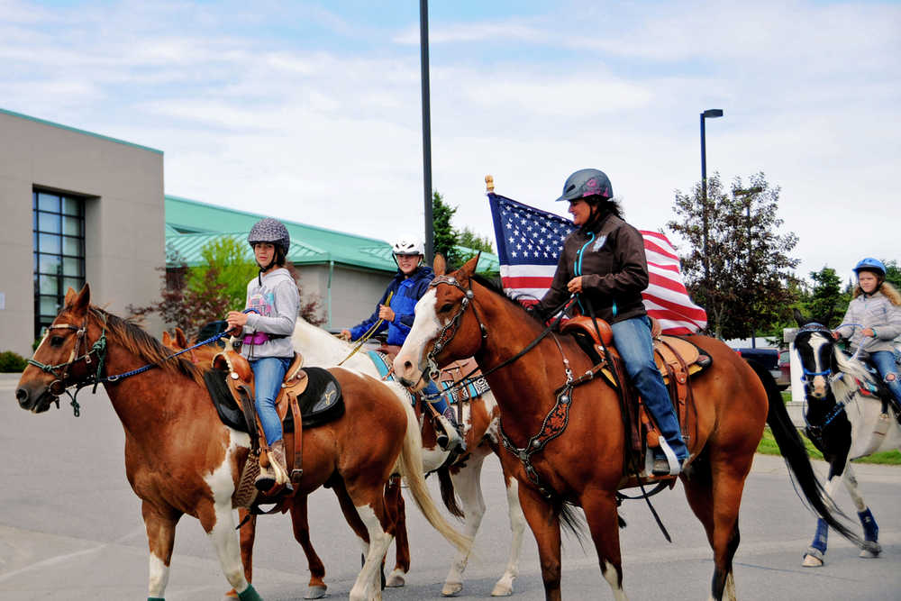 Photo by Elizabeth Earl/Peninsula Clarion A group of riders from Alaska C & C Horse Adventures on Jim Dahler Road just outside Soldotna practiced for the annual Fourth of July parade by riding down Trading Bay Road in Kenai, Alaska on Thursday, June 30, 2016. The Fourth of July parade will kick off in Kenai on Monday, July 4, 2016 on Fidalgo Avenue in Kenai.