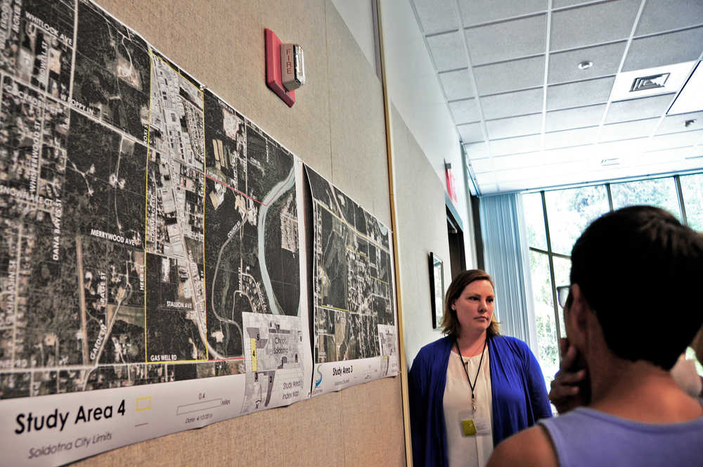 Photo by Elizabeth Earl/Peninsula Clarion Stephanie Queen (left), the director of economic development and planning for the City of Soldotna, listens to citizens' concerns about the city's possible annexation of areas currently outside the city boundaries at a public meeting at the Don Gilman River Center in Soldotna, Alaska on Thursday, June 30, 2016.