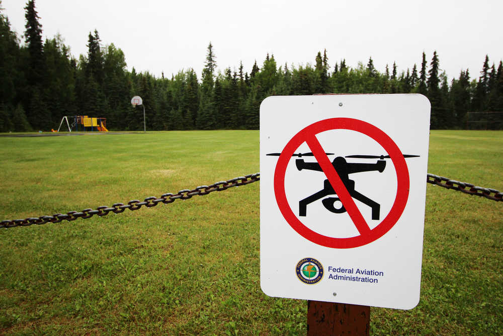 Ben Boettger/Peninsula Clarion A recently-installed "no drones" sign warns hobby drone owners not to fly at the Fourth Street Park on Friday, July 1 in Kenai. Kenai administrators have posted the signs in city parks near the airport to discourage drone pilots from flying where they may endanger incoming planes.