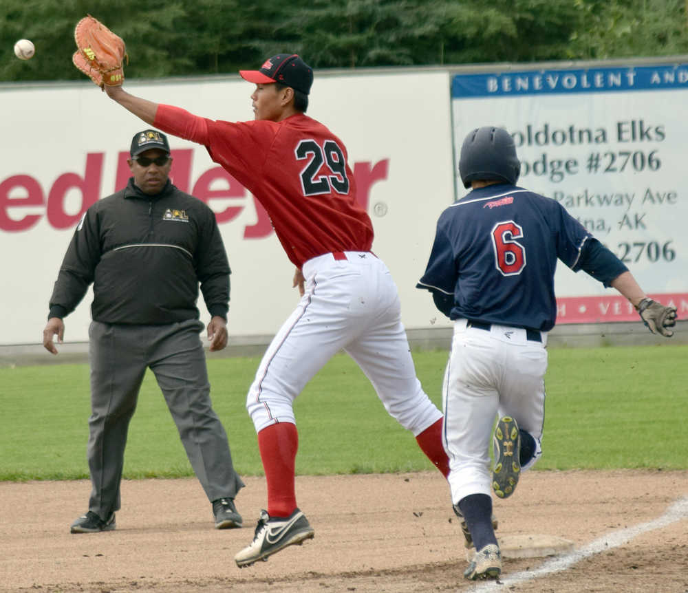 Photo by Jeff Helminiak/Peninsula Clarion Oilers first baseman Shih-Tsung Wang puts out Chinooks leadoff hitter Will Bass in the first inning Sunday at Coral Seymour Memorial Park in Kenai.