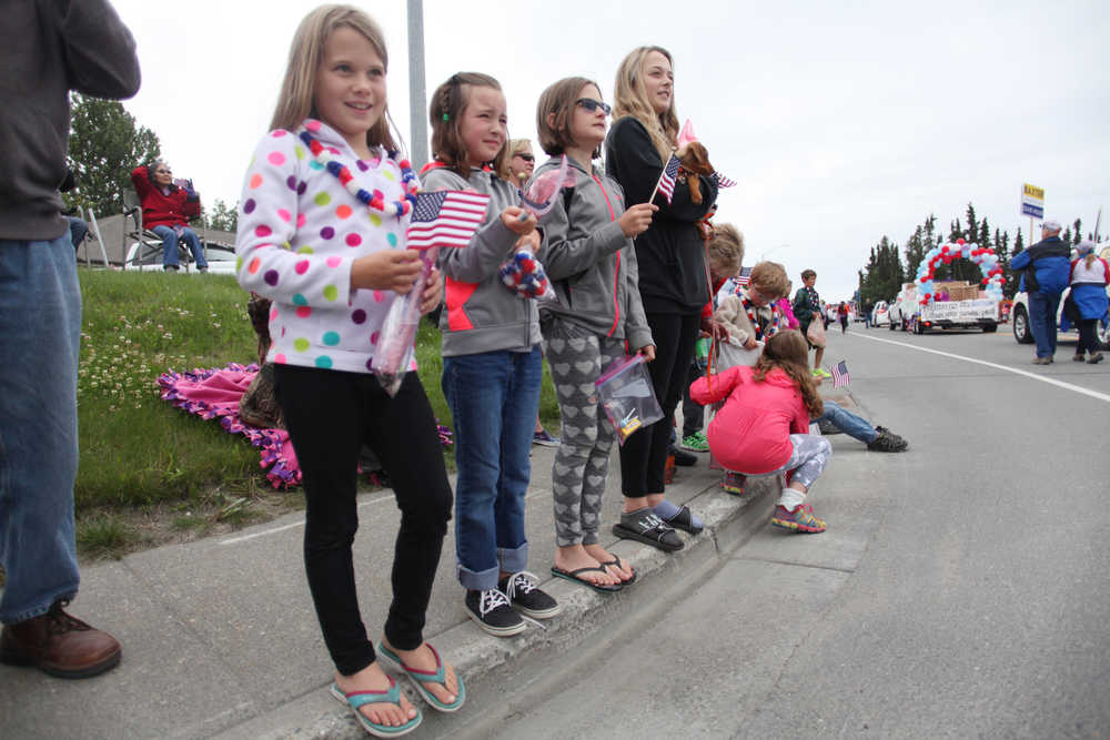 Photo by Kelly Sullivan/ Peninsula Clarion A group of onlookers watch the start of Kenai's July 4th Parade on Monday, July 4, 2016 in Kenai, Alaska.